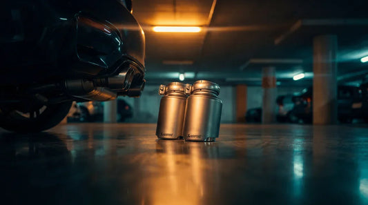 Akrapovic titanium exhaust tailpipe in low-light editorial setting