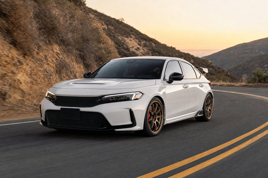 White 2023+ Honda Civic Type R FL5 with bronze forged wheels and red brake calipers cornering on a California canyon road at sunset