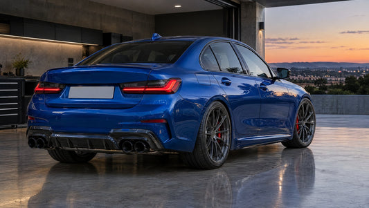 Blue G20 BMW 3 Series sport sedan in a garage with dark multi-spoke wheels, red brake calipers and a quad-tip aftermarket exhaust