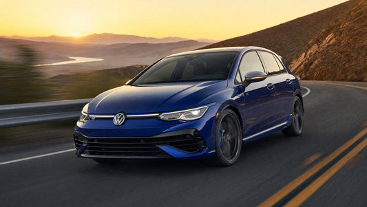 Blue MK8 Volkswagen Golf R driving on a canyon road at sunset
