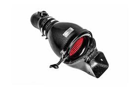 A carbon fiber eventuri intake with visible red filter 