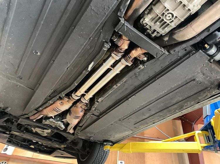 Underside of Ferrari 456GT showing exhaust routing where Capristo pre-muffler spare tubes fit