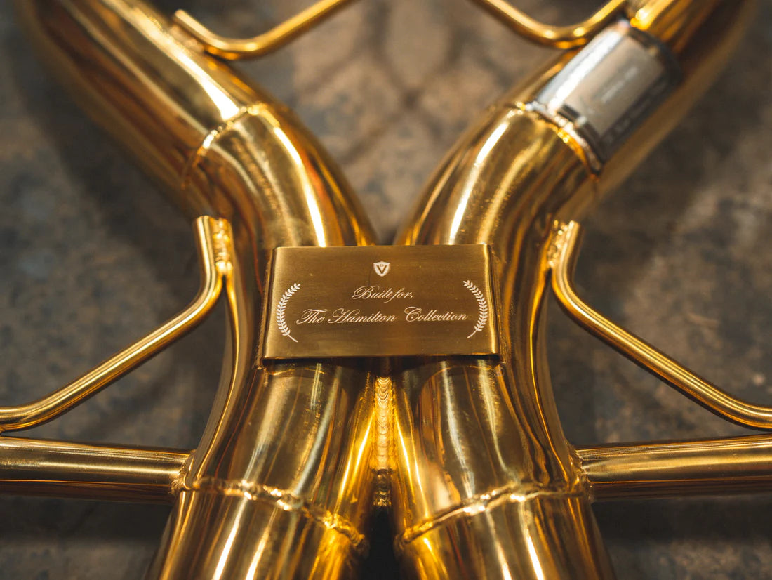 A close overview of Valvetronic Designs Sport Exhaust System's pipes on the ground (for Mclaren P1).