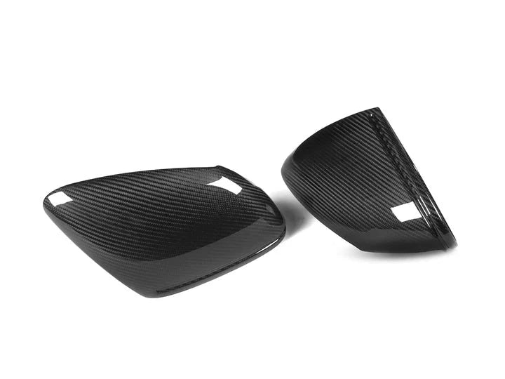 A front view of AUTOTECKNIC REPLACEMENT DRY CARBON MIRROR COVERS - PORSCHE 9J1 TAYCAN 2019+ with white background