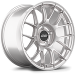 Silver alloy wheel with multi-spoke design, black center cap with logo, showing front face and profile view - APEX Wheels wheel for 18x10 ET36 5x130 - Race Silver