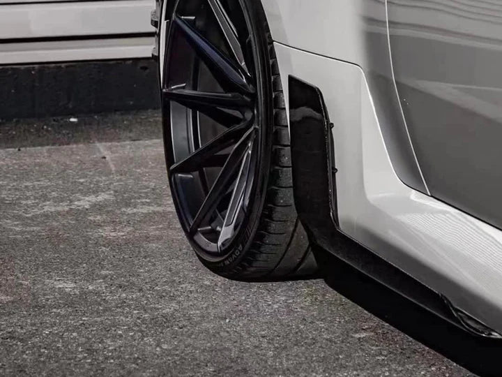 A close up view of AUTOTECKNIC DRY CARBON SIDE SKIRT WINGLET SET - BMW G87 M2 2023+ fitted on a car