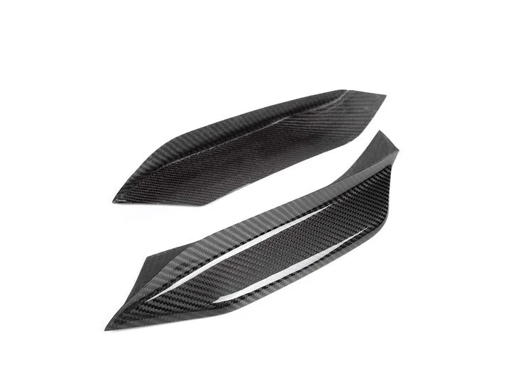 A close up view of AUTOTECKNIC DRY CARBON CORSA BUMPER TRIM - BMW F80 M3 | F82/ F83 M4 2014+ with white background