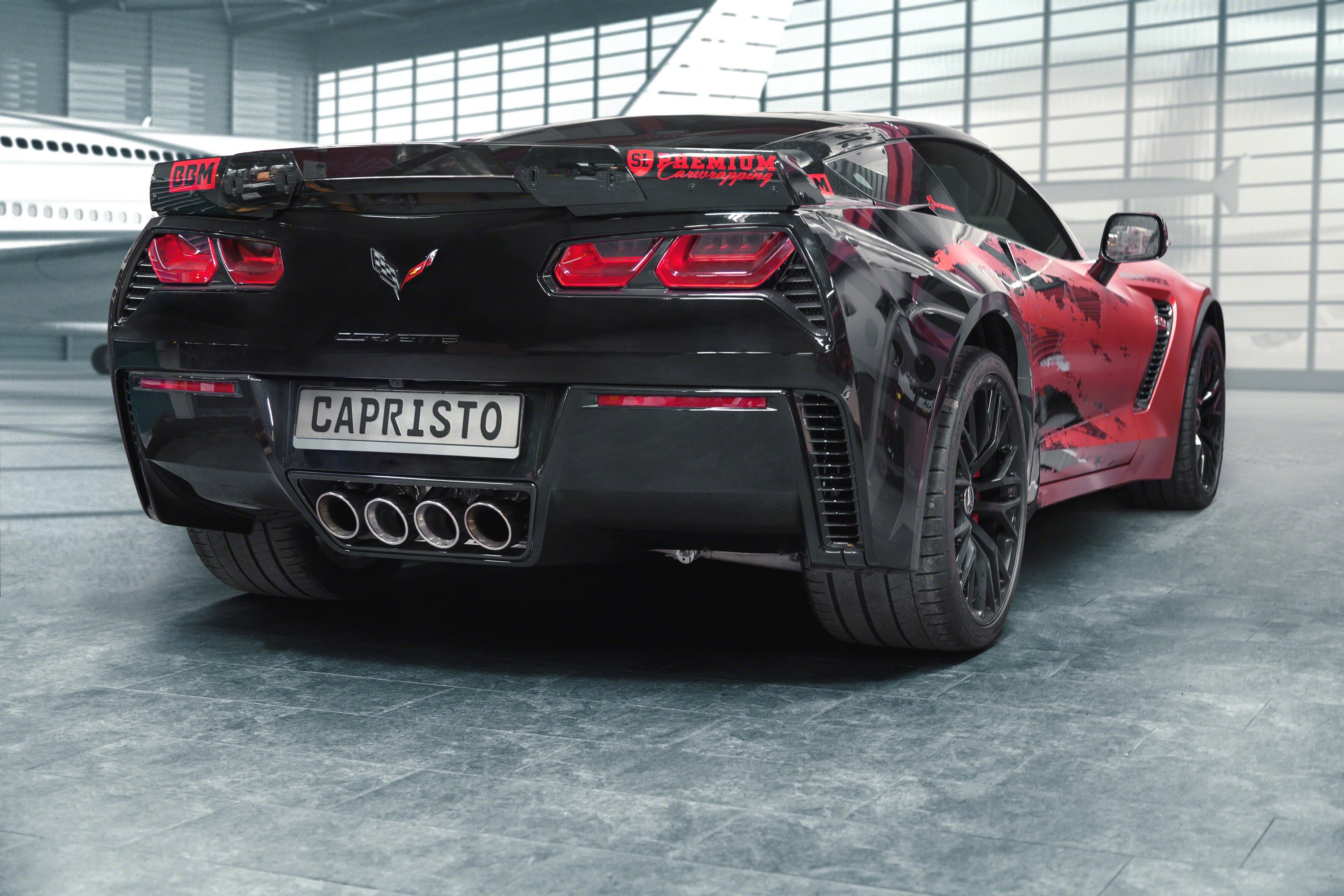 Black Corvette C7 Z06 rear three-quarter with the Capristo exhaust's quad center tips