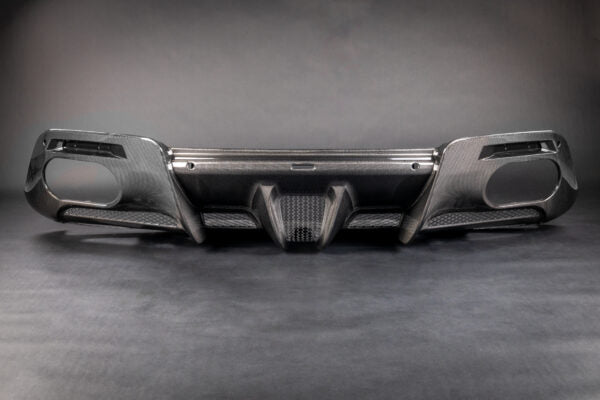 wide front view of Capristo Carbon Fiber Rear Diffuser For Ferrari Roma 2020-2024 with a black background