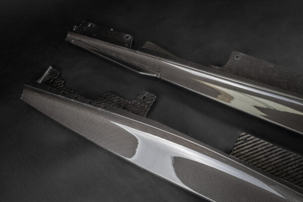 close top view of Capristo Carbon Fiber Side Skirts (with Large Fin) for Ferrari Roma 2020-2024 with black background