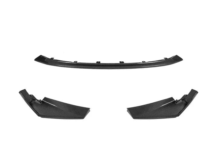 A front view of parts of AUTOTECKNIC DRY CARBON COMPETITION SPORT FRONT AERO LIP - BMW G80 M3 | G82/ G83 M4 2021+ with white bakground