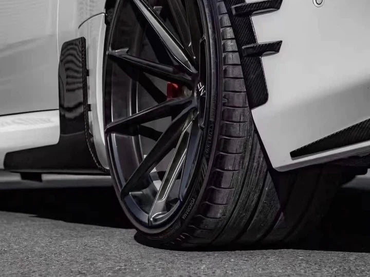 A close up view of AUTOTECKNIC DRY CARBON SIDE SKIRT WINGLET SET - BMW G87 M2 2023+ fitted on a car