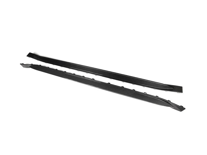 A front view of AUTOTECKNIC DRY CARBON OEM SPEC SIDE SKIRT - BMW G80 M3 2021+ with white background