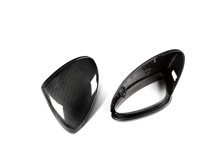 A top view of AUTOTECKNIC REPLACEMENT DRY CARBON MIRROR COVERS - PORSCHE 958.2 CAYENNE 2015-2018 with white background
