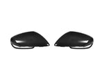 A back view of AUTOTECKNIC REPLACEMENT DRY CARBON MIRROR COVERS - PORSCHE 9J1 TAYCAN 2019+ with white background
