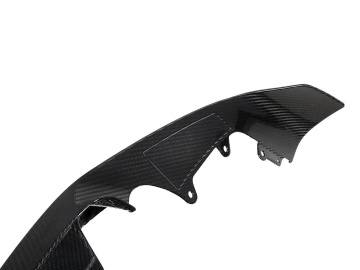 A close up view of AUTOTECKNIC DRY CARBON PERFORMANTE FRONT AERO LIP - BMW F87 M2 COMPETITION 2018+ with white background