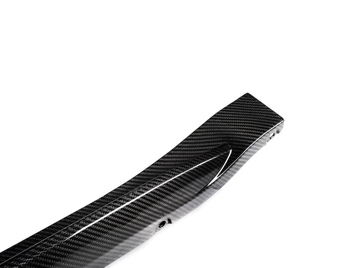 A close up view of AUTOTECKNIC DRY CARBON OEM SPEC SIDE SKIRT - BMW G82/ G83 M4 2021+ with white background