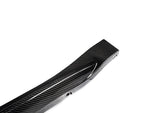 A close up view of AUTOTECKNIC DRY CARBON OEM SPEC SIDE SKIRT - BMW G82/ G83 M4 2021+ with white background