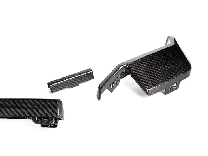 A close up view of AUTOTECKNIC DRY CARBON REAR DIFFUSER TRIM SET Gloss Finish - BMW G80 M3 | G82/ G83 M4 2021+ with white background