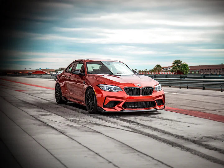 A wide view of AUTOTECKNIC DRY CARBON PERFORMANTE FRONT AERO LIP - BMW F87 M2 COMPETITION 2018+ fitted on a car