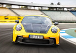 A front view of a yellow 911 GT3 on a race track fitted with TECHART Front Panel Air Intake for Porsche 992 GT3 / GT3 RS 2020+