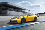 A side view of a yellow 911 GT3 on a race track fitted with TECHART Front Panel Air Intake for Porsche 992 GT3 / GT3 RS 2020+