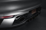 A close up view of TECHART Standard Rear Bumper Multi-part Diffuser Porsche 992 Carrera & Targa fitted on a grey car