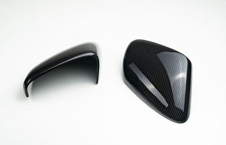 A top view of TECHART Carbon Matt Side Mirror Trims Porsche 992 Carrera / Targa / Turbo with white background