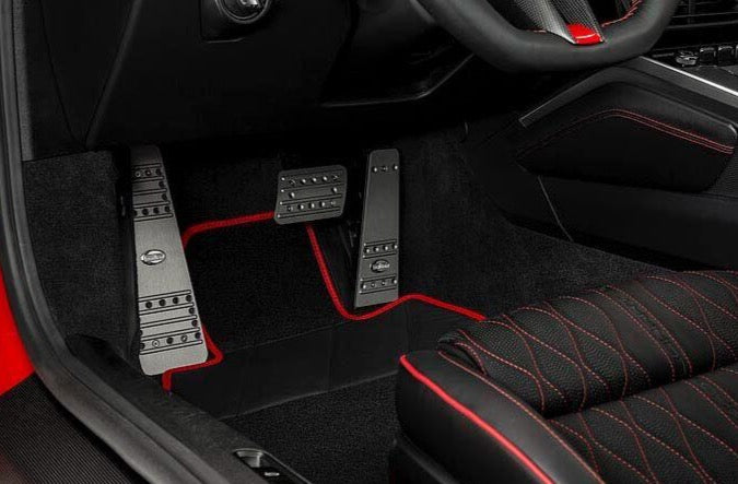 A close up view of TECHART Titanium Anodized 3 Pieces Pedal Kit w/ TechArt Logo Porsche 992 Carrera / Targa / Turbo fitted in a car