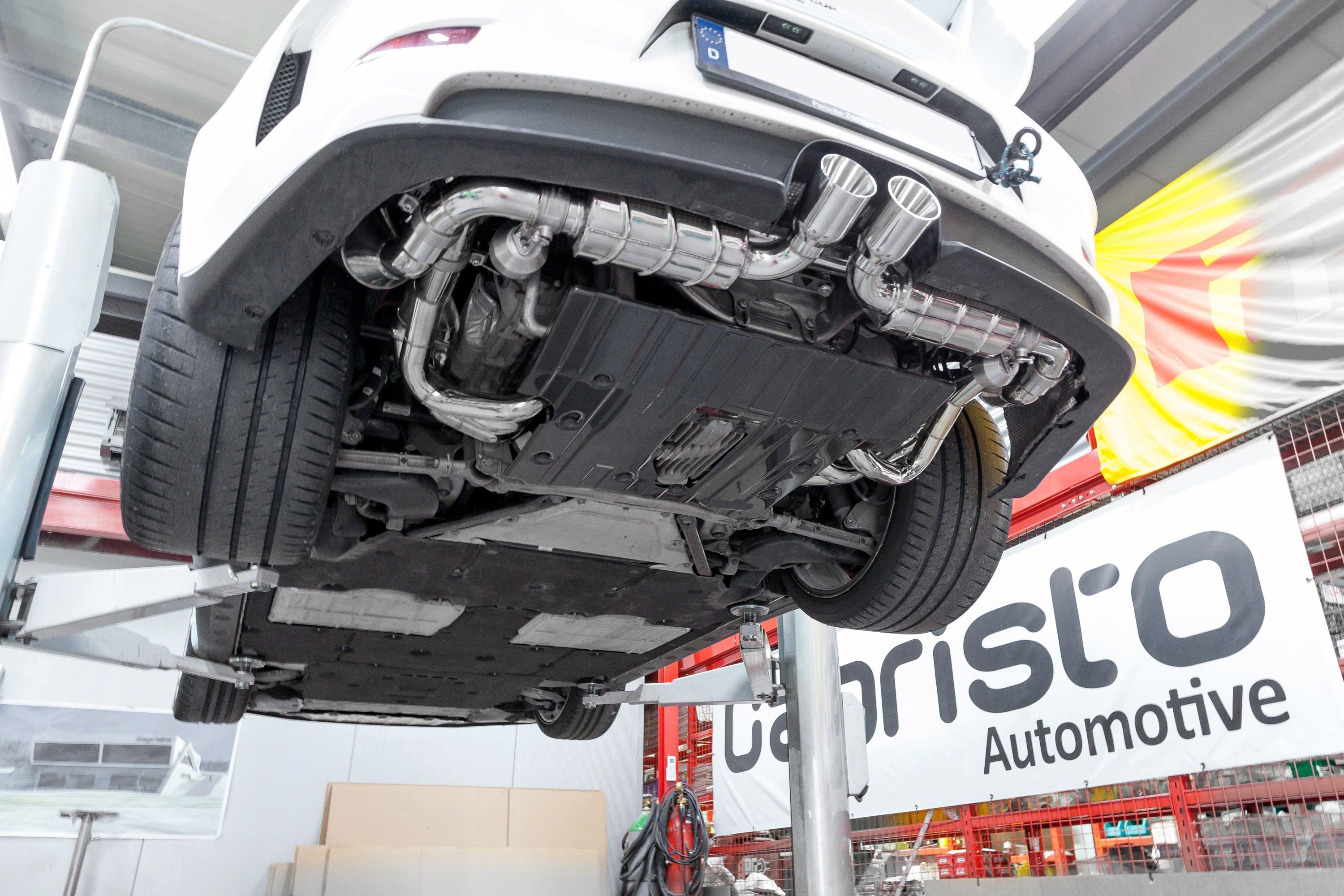 White Porsche 991 GT3 on lift with Capristo exhaust set
