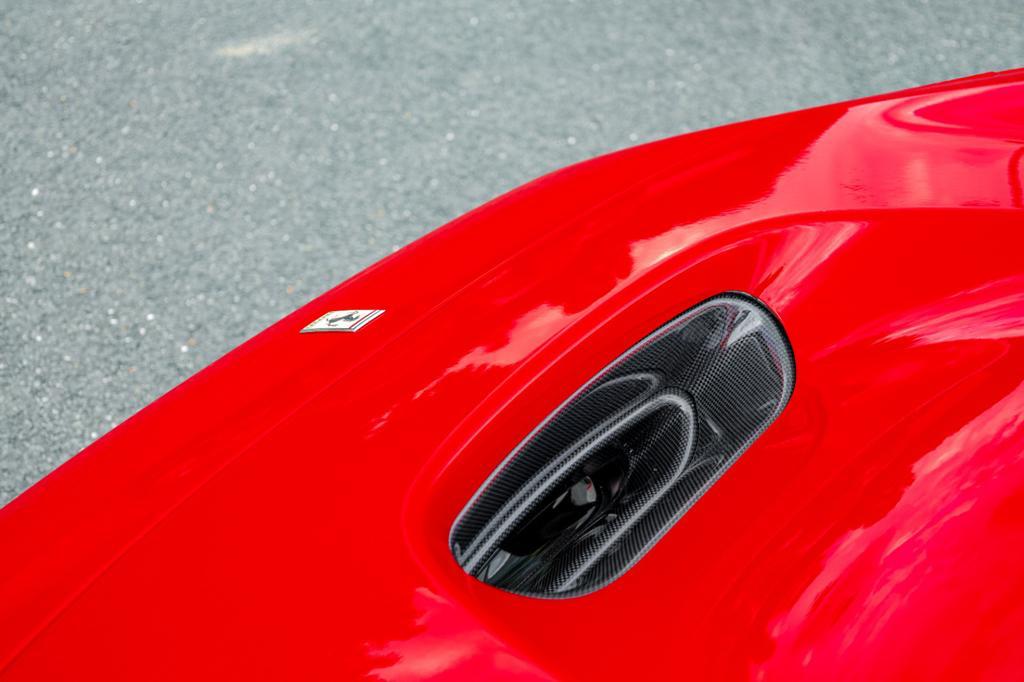 Close-up of Capristo carbon front bonnet air vent on a red F8