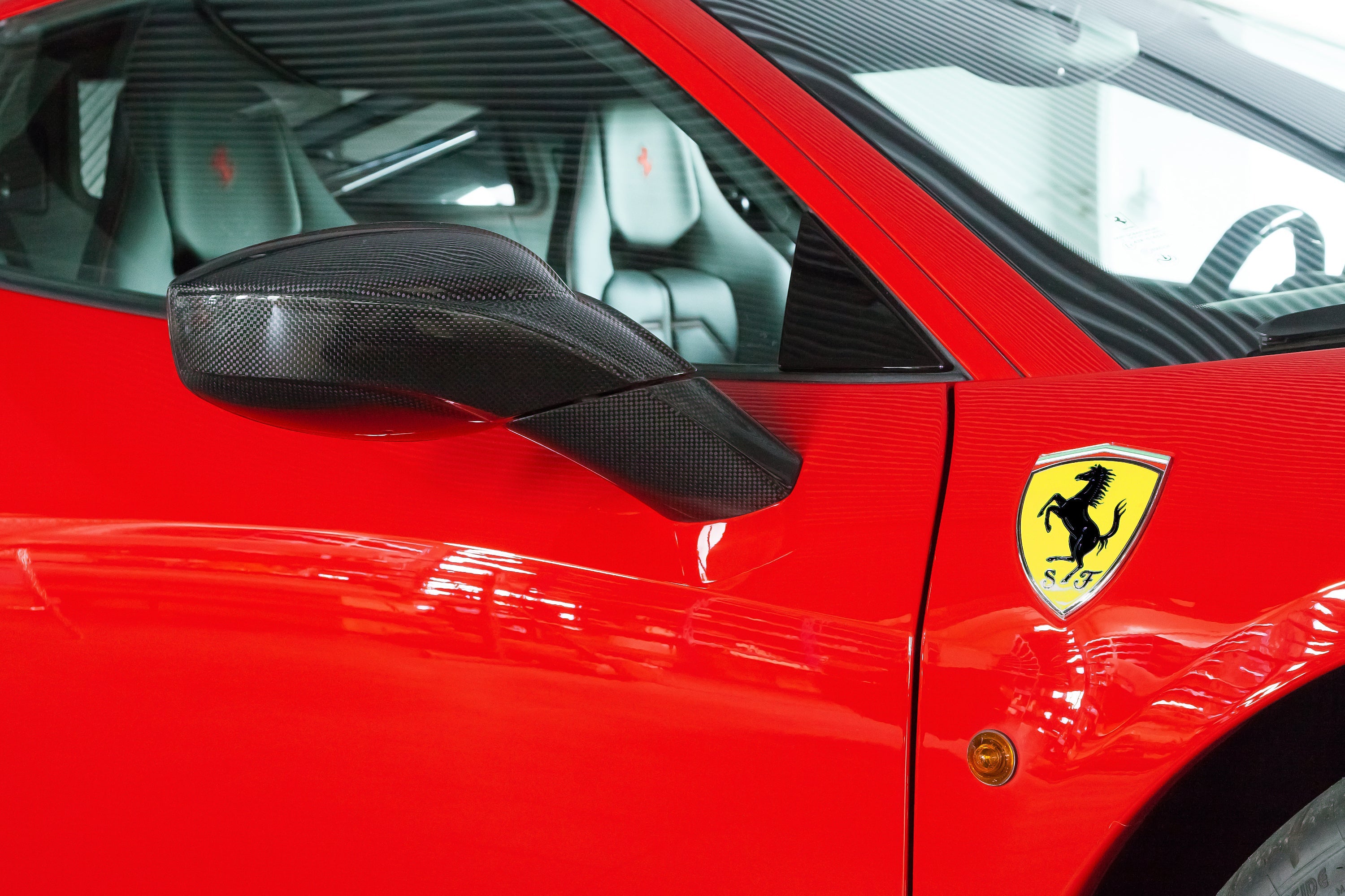 Capristo carbon fiber mirror case on a red Ferrari 458, side view