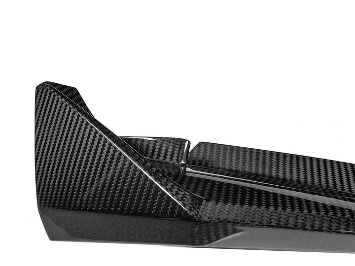 A close up view of AUTOTECKNIC DRY CARBON COMPETITION SPORT FRONT AERO LIP - BMW G80 M3 | G82/ G83 M4 2021+ with white background