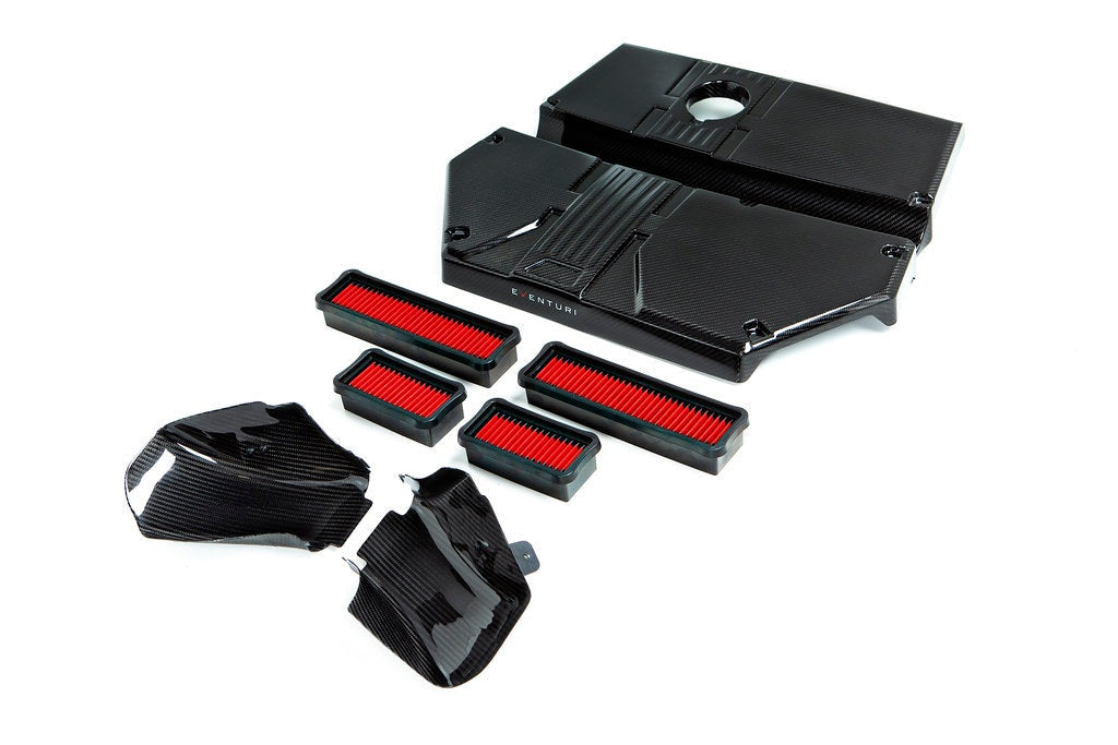 Carbon fiber intake lid with scoops and red air filters displayed as complete kit on white background - Eventuri intake lid with scoops for BMW X3M