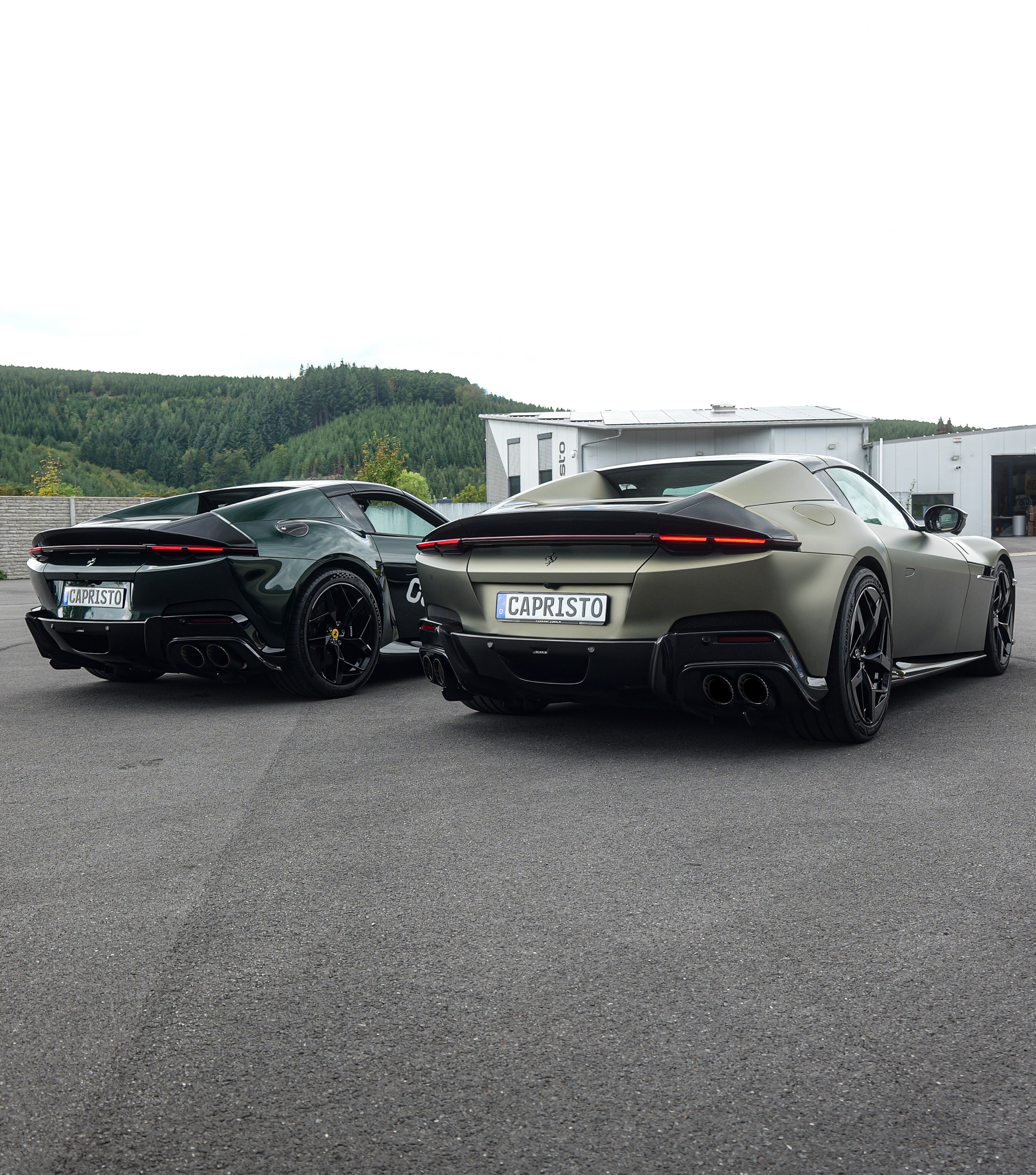 Two Ferrari 12Cilindri from behind with Capristo exhausts outside the factory