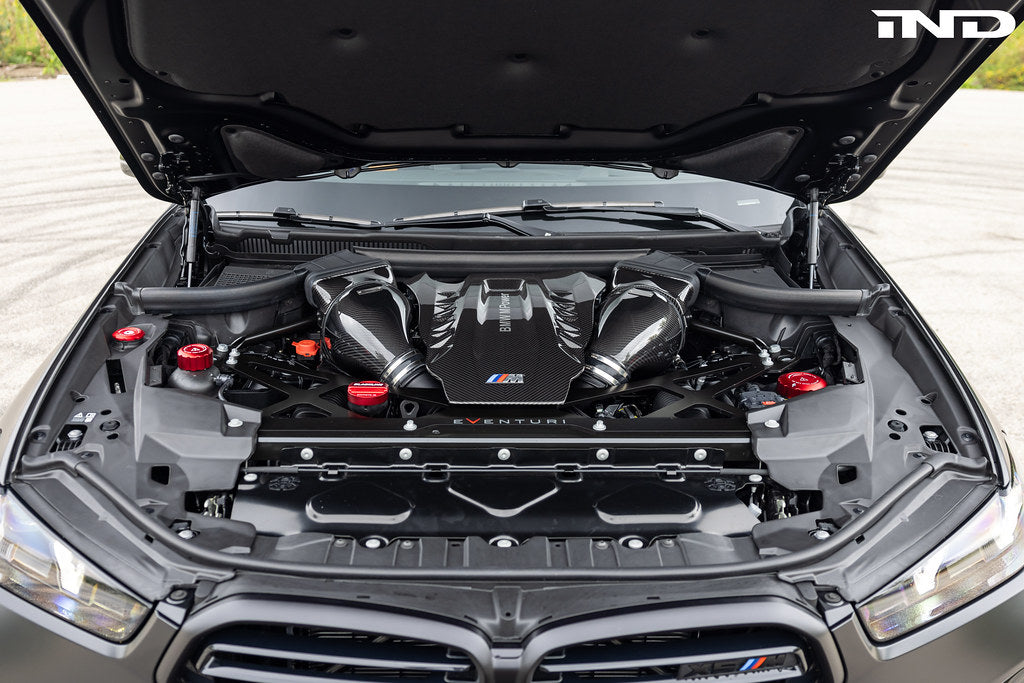 A top view of Eventuri Black Carbon Intake System For BMW F9X X5M / X6M / G09 XM fitted on a car