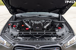 A top view of Eventuri Black Carbon Intake System For BMW F9X X5M / X6M / G09 XM fitted on a car
