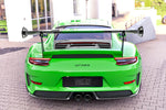 A wide back view of TECHART Rear Spoiler Profile Carbon "glossy" for Porsche 991 GT3 RS fitted on a green car 