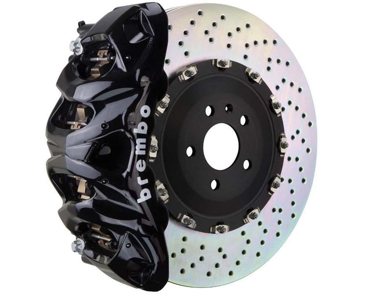 A front view of Brembo GT Front Big Brake Kit 412x38 2-Piece 8-Piston Drilled Rotors for Cadillac Escalade V-Series in black caliper with white background