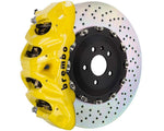 A front view of Brembo GT Front Big Brake Kit 412x38 2-Piece 8-Piston Drilled Rotors for Cadillac Escalade V-Series in yellow caliper with white background