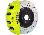 A front view of Brembo GT Front Big Brake Kit 412x38 2-Piece 8-Piston Drilled Rotors for Cadillac Escalade V-Series in fluorescent yellow caliper with white background