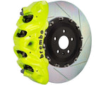 A front view of Brembo GT Front Big Brake Kit 412x38 2-Piece 8-Piston Slotted Rotors for Cadillac Escalade V-Series in fluorescent yellow caliper with white background