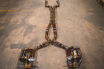 Wide overhead view of the complete Valvetronic Designs titanium exhaust system laid out on a workshop floor.
