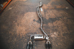 Overhead view of the full Valvetronic Designs Equal Length Valved Sport Exhaust System laid out on a concrete floor.