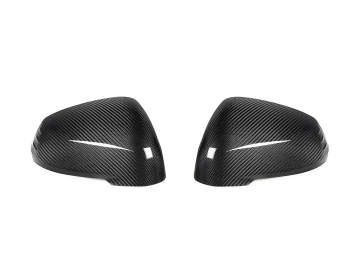 A front view of AUTOTECKNIC DRY CARBON FIBER MIRROR COVER SET - BMW U11 X1 2023+ with white background
