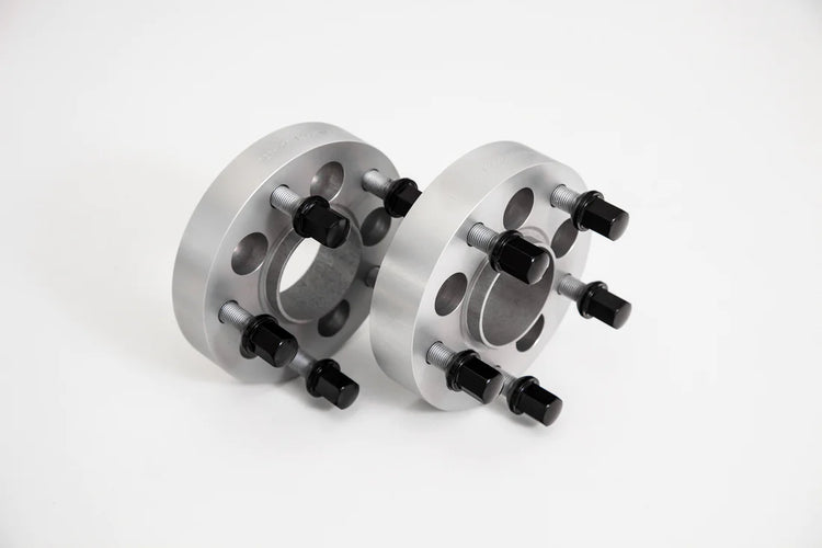 A front view of TECHART Bolt Circle Adapter 35mm, BC 112/5 - 130/5 for Porsche Macan with a grey background