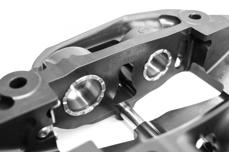 A close up view of CP9450 of the AP Racing by Essex Radi-CAL Competition Brake Kit (Rear CP9450/365mm)- Cadillac CTS-V 2009-2015 (V2) with a white background