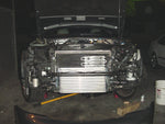 A front view of the Evolution Racewerks Audi A4 (B6) Competition Series Front Mount Intercooler (FMIC) Kit fitted on a open car