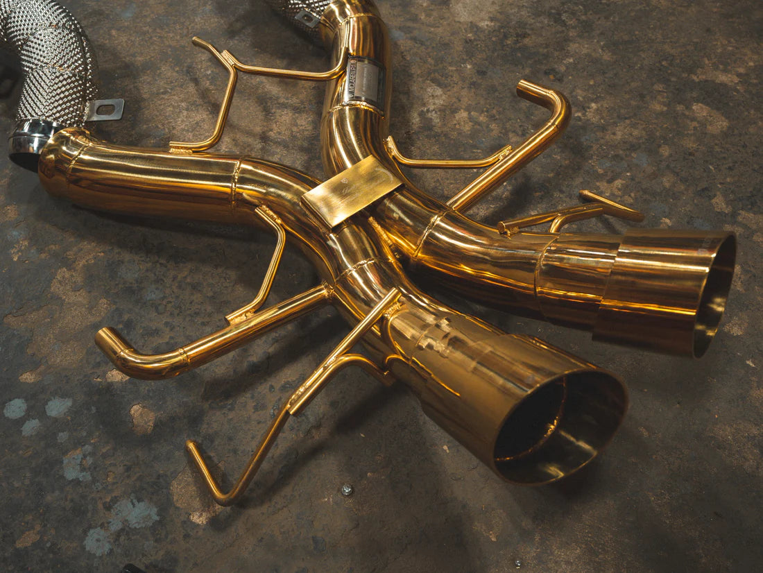 A top overview of Valvetronic Designs Sport Exhaust System's exhaust tips on the ground (for Mclaren P1).