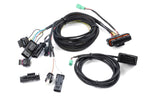 Detailed view of the Dinan PCU plug-and-play wiring harness, featuring factory-style connectors for a seamless, non-invasive installation into the BMW engine's sensors.